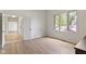 Bright, neutral bedroom with a large window, light wood flooring, and white trim at 1941 Orchard Ct, Carmel, IN 46280