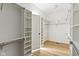 Walk-in closet with custom shelving and laminate flooring for organized storage at 1941 Orchard Ct, Carmel, IN 46280