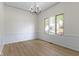 Dining room with white wainscoting and a large window offering natural light at 1941 Orchard Ct, Carmel, IN 46280