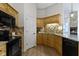 Well-lit kitchen featuring granite countertops, stainless appliances, and wood cabinetry at 1941 Orchard Ct, Carmel, IN 46280