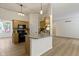 Open kitchen with stainless steel appliances, island seating, granite countertops, and wooden cabinets at 1941 Orchard Ct, Carmel, IN 46280