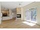 Open-concept living space with a stone fireplace, open kitchen, and sliding glass doors at 1941 Orchard Ct, Carmel, IN 46280