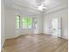 Main bedroom with large windows, tray ceilings, and wood-style flooring at 1941 Orchard Ct, Carmel, IN 46280