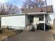 Back exterior of home with stairs, porch, and patio at 21 Reo St, Columbus, IN 47201