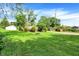 Grassy backyard featuring a fire pit, and mature trees providing a serene outdoor environment at 2150 S Emerson Ave, Indianapolis, IN 46203