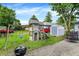 Grassy backyard featuring a playground set, trampoline, grill, and storage shed, ideal for Gathering enjoyment at 2150 S Emerson Ave, Indianapolis, IN 46203