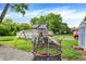Spacious backyard featuring a playground, trampoline, and storage shed, perfect for outdoor activities at 2150 S Emerson Ave, Indianapolis, IN 46203