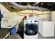 Basement laundry area with utility sink and modern, front-load washer and dryer at 2150 S Emerson Ave, Indianapolis, IN 46203