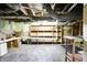 Spacious unfinished basement with exposed beams, utilities, and storage shelving at 2150 S Emerson Ave, Indianapolis, IN 46203