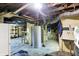 Spacious basement area with exposed piping, shelving, and water heating unit at 2150 S Emerson Ave, Indianapolis, IN 46203