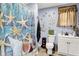 Coastal themed bathroom featuring a single sink vanity, toilet, and shower/tub combo at 2150 S Emerson Ave, Indianapolis, IN 46203