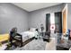 Bedroom with gray walls features a bed, side table, and laminate floors at 2150 S Emerson Ave, Indianapolis, IN 46203