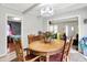 Bright dining room features a wood table with decorative centerpiece, wood floors, and decorative light fixture at 2150 S Emerson Ave, Indianapolis, IN 46203