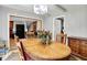 A cozy dining room featuring a wood table and views into the kitchen and other rooms at 2150 S Emerson Ave, Indianapolis, IN 46203
