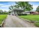 This home features a long driveway, complemented by a well-manicured lawn and charming facade at 2150 S Emerson Ave, Indianapolis, IN 46203
