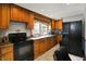 The kitchen includes stainless steel appliances, oak cabinets, tile flooring and countertop space at 2150 S Emerson Ave, Indianapolis, IN 46203