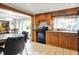 View of kitchen and dining area with tile floors, stainless steel appliances, and oak cabinets at 2150 S Emerson Ave, Indianapolis, IN 46203