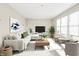Bright and airy living room featuring stylish decor, large windows, and a comfortable seating area at 2150 S Emerson Ave, Indianapolis, IN 46203