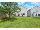 This home features a spacious backyard with green grass and privacy fence at 2473 Shadow Bend Dr, Columbus, IN 47201