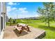 Enjoy outdoor living with a patio, colorful picnic table, and grill with community green space views at 2473 Shadow Bend Dr, Columbus, IN 47201