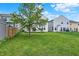 This home features a spacious backyard with green grass at 2473 Shadow Bend Dr, Columbus, IN 47201
