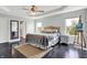 Bright bedroom featuring dark wood floors, a ceiling fan, and tray ceiling at 2473 Shadow Bend Dr, Columbus, IN 47201