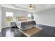 Spacious bedroom with dark wood floors, tray ceiling, and abundant natural light at 2473 Shadow Bend Dr, Columbus, IN 47201