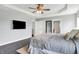 Large bedroom with dark wood floors, ceiling fan, and a view into the bathroom at 2473 Shadow Bend Dr, Columbus, IN 47201