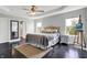 Bright bedroom featuring dark wood floors, a ceiling fan, and tray ceiling at 2473 Shadow Bend Dr, Columbus, IN 47201
