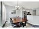 Bright dining area with a wooden table, black chairs, and stainless steel appliances in the kitchen at 2473 Shadow Bend Dr, Columbus, IN 47201