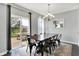 Bright dining area with a wooden table, black chairs, and sliding glass doors to the patio at 2473 Shadow Bend Dr, Columbus, IN 47201