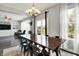Bright dining area with a wooden table, black chairs, and access to the living room at 2473 Shadow Bend Dr, Columbus, IN 47201