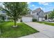 A charming two-story home with a lush lawn and mature tree in a Gathering-friendly neighborhood at 2473 Shadow Bend Dr, Columbus, IN 47201