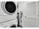 Bright laundry room with a stacked washer and dryer and a large closet at 2473 Shadow Bend Dr, Columbus, IN 47201