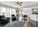 Bright living room with hardwood floors, large windows, and views of the dining area and backyard at 2473 Shadow Bend Dr, Columbus, IN 47201