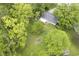 Aerial view of a home with a fire pit in the backyard, surrounded by lush greenery at 2807 Westleigh Dr, Indianapolis, IN 46268