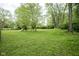 Large backyard featuring a swing set and plenty of space for outdoor recreation and relaxation at 2807 Westleigh Dr, Indianapolis, IN 46268