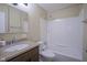 This bathroom features a shower and bathtub combination, with granite countertops at 2807 Westleigh Dr, Indianapolis, IN 46268