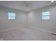 Clean bedroom with neutral paint, carpet and two windows, and a ceiling fan at 2807 Westleigh Dr, Indianapolis, IN 46268