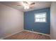 This bedroom has modern flooring, a ceiling fan, and a window at 2807 Westleigh Dr, Indianapolis, IN 46268