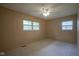 Carpeted bedroom with two windows and a ceiling fan at 2807 Westleigh Dr, Indianapolis, IN 46268