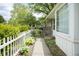 Charming walkway leads to a well-maintained home with manicured landscaping and white picket fence at 2807 Westleigh Dr, Indianapolis, IN 46268