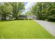 Charming ranch-style home featuring a sprawling green lawn and a long private driveway at 2807 Westleigh Dr, Indianapolis, IN 46268