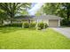 Charming single-story home with well-manicured lawn, mature trees, and an attached one-car garage at 2807 Westleigh Dr, Indianapolis, IN 46268
