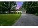 Dusk view of a cozy ranch-style home with mature landscaping and a private driveway at 2807 Westleigh Dr, Indianapolis, IN 46268