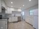 Bright kitchen features white cabinetry, stainless steel appliances, and granite countertops at 2807 Westleigh Dr, Indianapolis, IN 46268