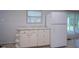 Shows white cabinets and a refrigerator in the kitchen with an adjacent screened porch at 2807 Westleigh Dr, Indianapolis, IN 46268