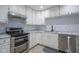 Modern kitchen with stainless steel appliances, updated countertops, and white cabinetry at 2807 Westleigh Dr, Indianapolis, IN 46268