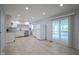 Overview of the kitchen and the adjacent dining area with a fireplace and access to a screened porch at 2807 Westleigh Dr, Indianapolis, IN 46268