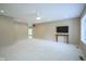 Open-concept living area featuring plush carpeting, a ceiling fan, and natural light from large windows at 2807 Westleigh Dr, Indianapolis, IN 46268